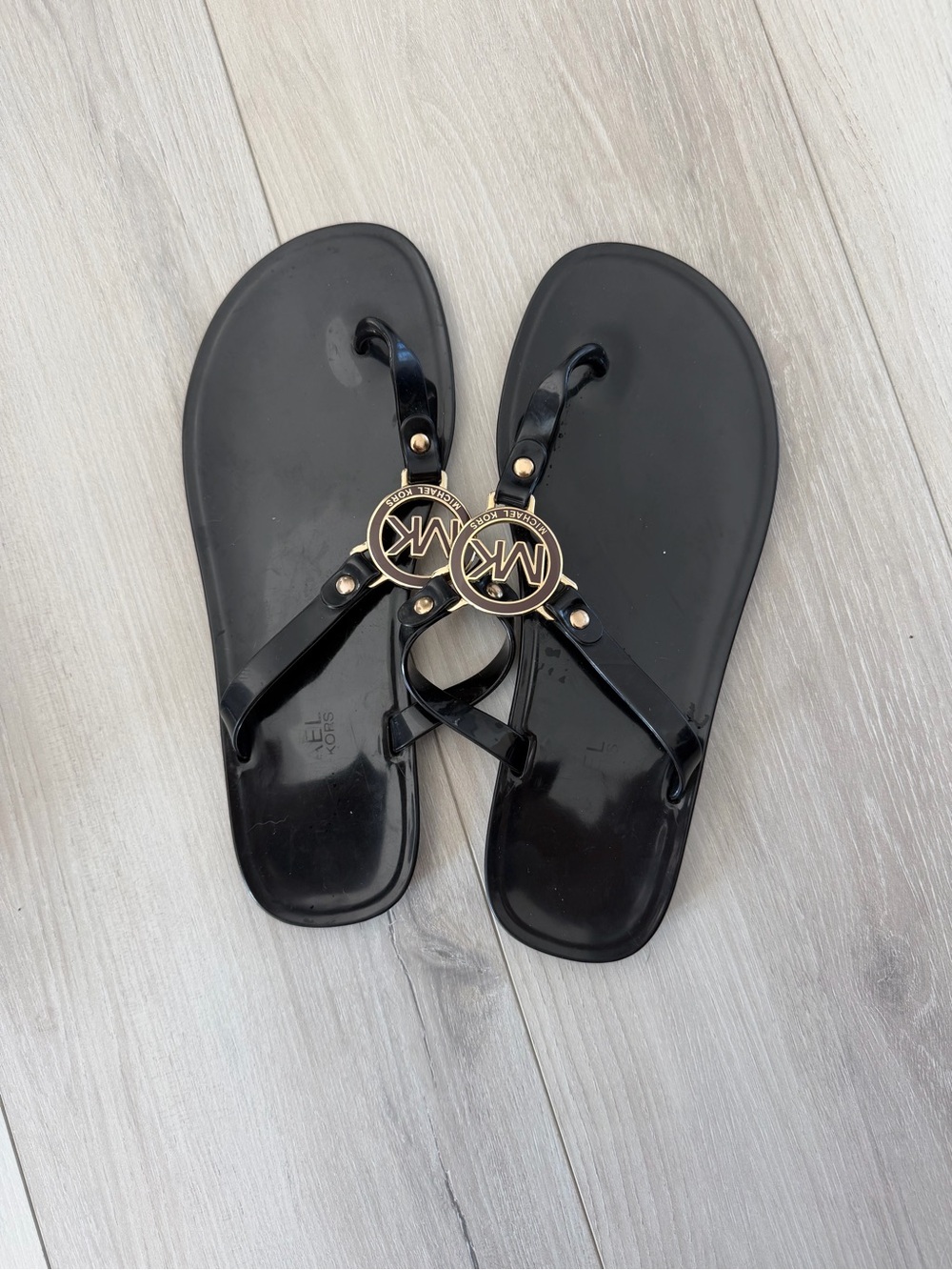Michael Kors Black Jelly Logo Thong Sandals with Gold MK Medallions